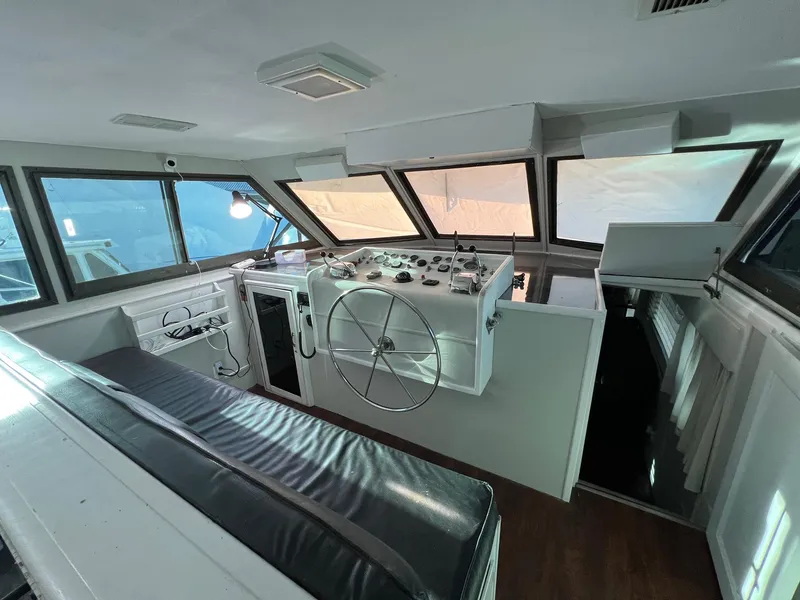 Slide: The Image of Interior helm of 1975 Hatteras 58 Motor Yacht with steering wheel and controls. - 12