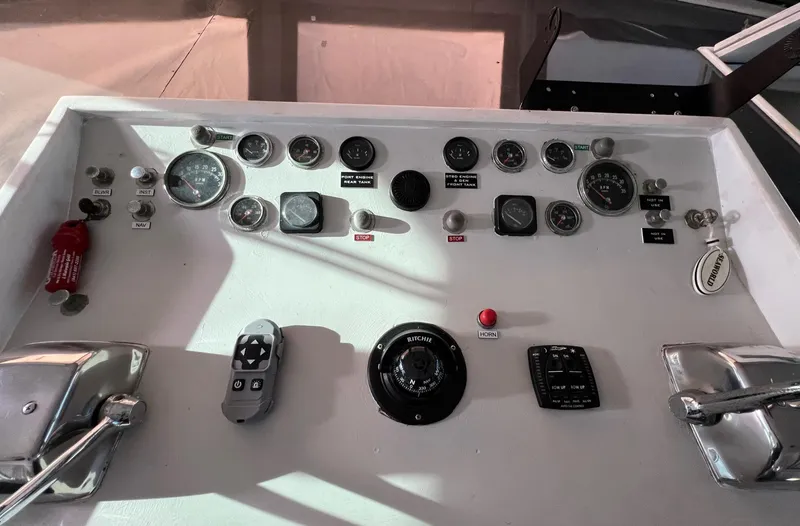 Slide: The Image of Control panel of a 1975 Hatteras 58 Motor Yacht with gauges and switches. - 13