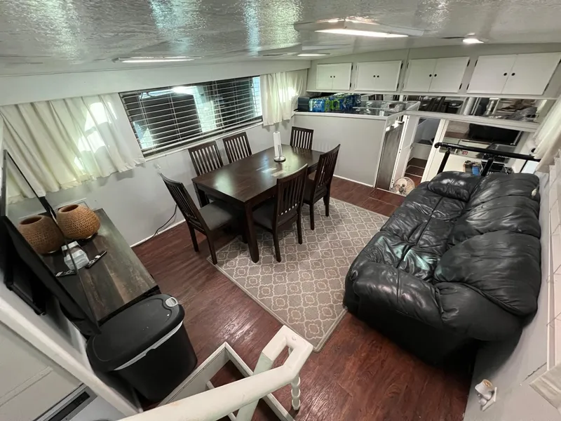 Slide: The Image of Interior of 1975 Hatteras 58 Motor Yacht with dining area and leather sofa. - 15