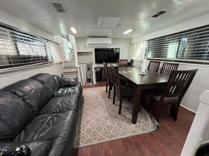 Slide: The Image of Interior of 1975 Hatteras 58 Motor Yacht with leather sofa and dining table. - 16