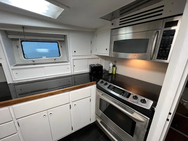 Slide: The Image of 1975 Hatteras 58 Motor Yacht kitchen with modern appliances and sleek cabinetry. - 20