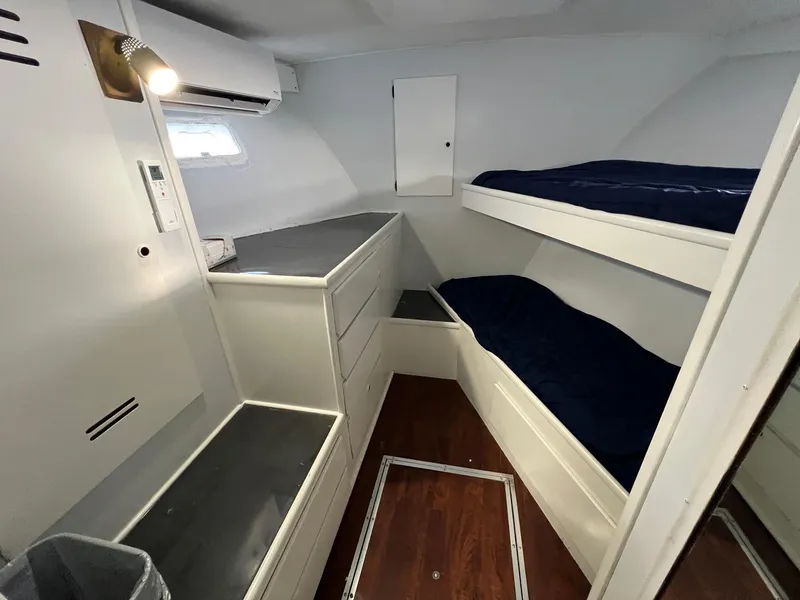 Slide: The Image of Interior cabin of a 1975 Hatteras 58 Motor Yacht with bunk beds and storage. - 21
