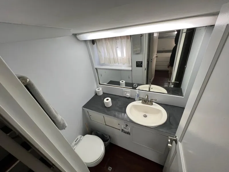 Slide: The Image of 1975 Hatteras 58 Motor Yacht bathroom with sink, mirror, and toilet. - 22