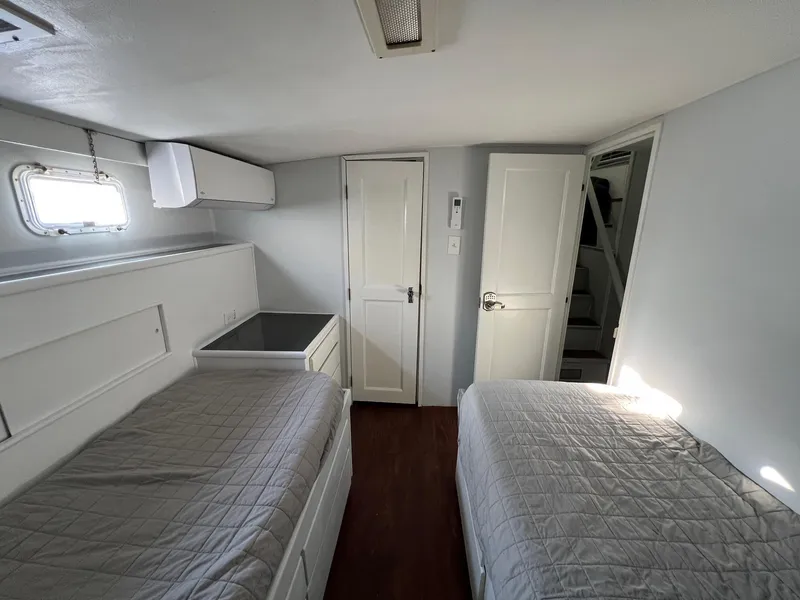 Slide: The Image of Interior cabin of 1975 Hatteras 58 Motor Yacht with twin beds and white decor. - 24