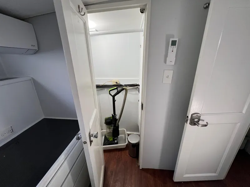 Slide: The Image of Interior of 1975 Hatteras 58 Motor Yacht with storage area and cleaning equipment. - 25