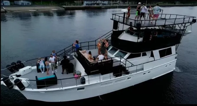 Slide: The Image of 1975 Hatteras 58 Motor Yacht with people enjoying a party on deck. - 3