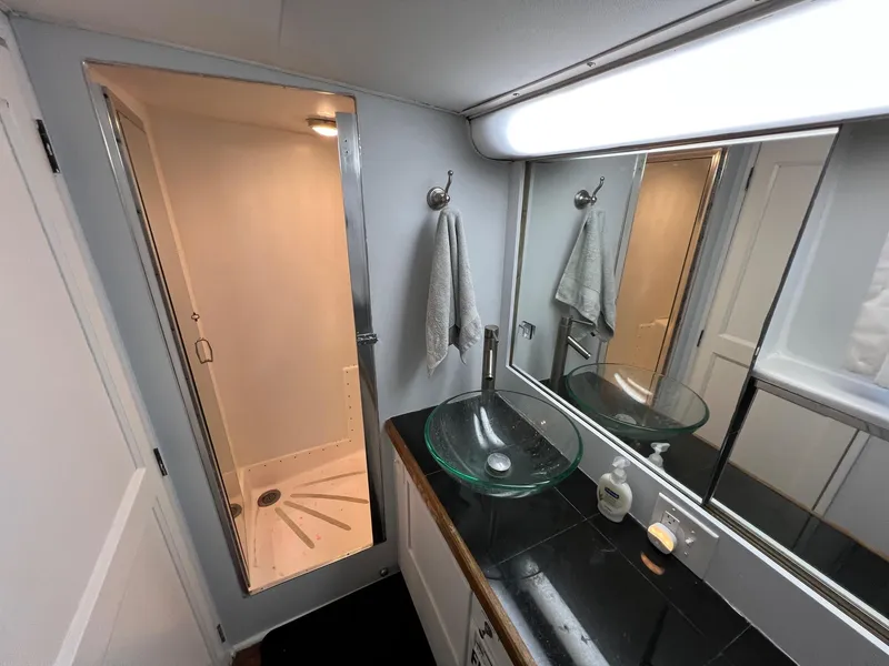 Slide: The Image of 1975 Hatteras 58 Motor Yacht bathroom with glass sink and shower. - 31