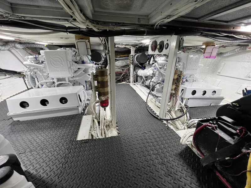 Slide: The Image of Engine room of a 1975 Hatteras 58 Motor Yacht, featuring dual engines and organized wiring. - 36