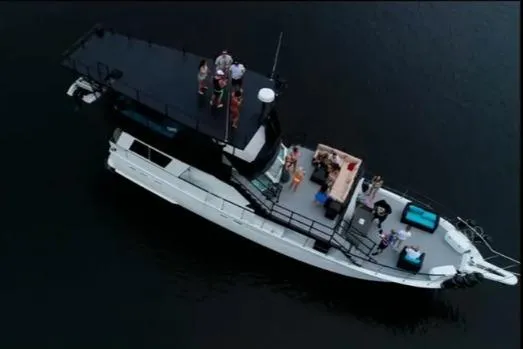 Slide: The Image of Aerial view of 1975 Hatteras 58 Motor Yacht with people on deck. - 4