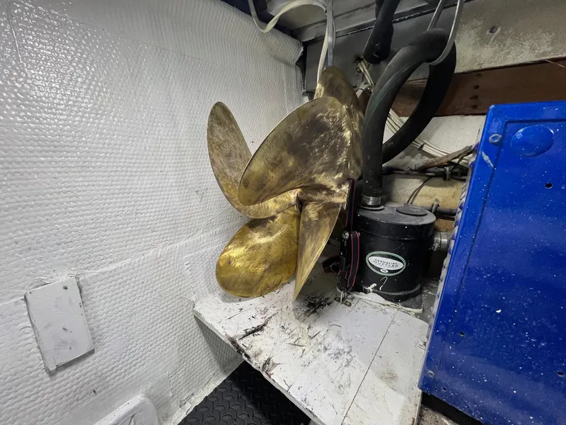 Slide: The Image of 1975 Hatteras 58 Motor Yacht engine room with brass propeller. - 42