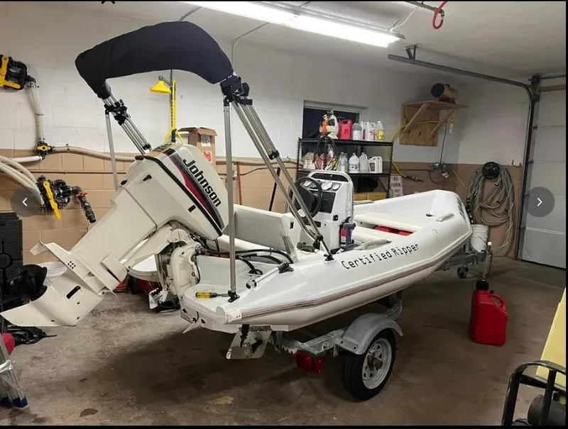 Slide: The Image of Inflatable boat with Johnson motor in garage, associated with 1975 Hatteras 58 Motor Yacht. - 43