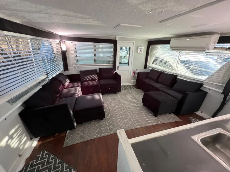 Slide: The Image of Interior of 1975 Hatteras 58 Motor Yacht with modern seating and large windows. - 6