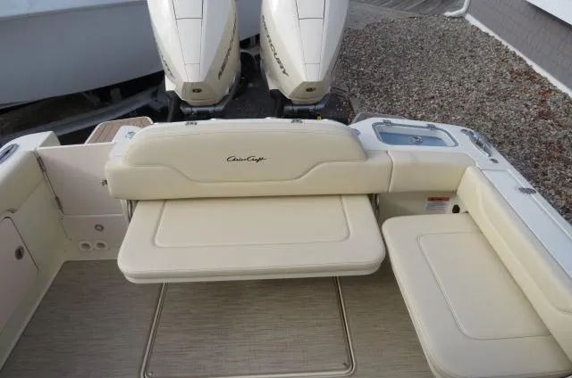 Slide: The Image of 2025 Chris-Craft Catalina 28 boat with beige seating and dual outboard engines. - 11