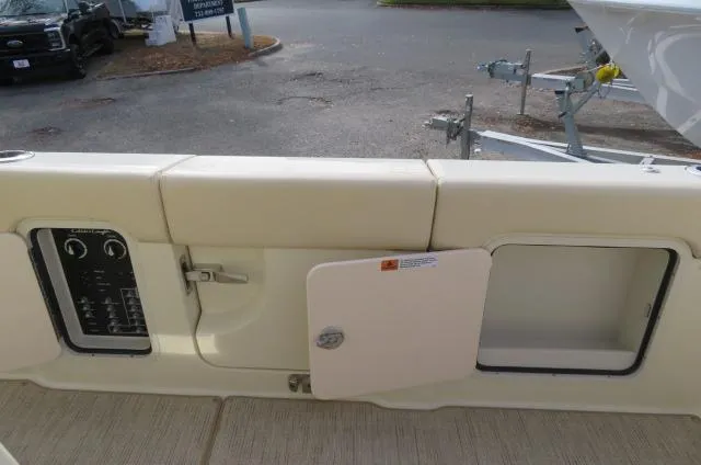 Slide: The Image of 2025 Chris-Craft Catalina 28 boat interior with open storage compartments and control panel. - 12