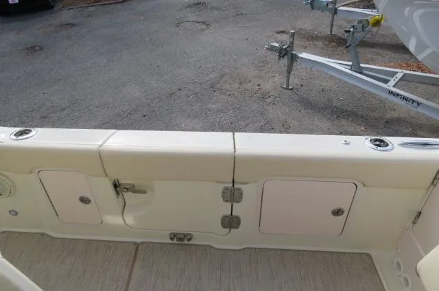 Slide: The Image of 2025 Chris-Craft Catalina 28 boat deck with storage compartments and trailer in background. - 13