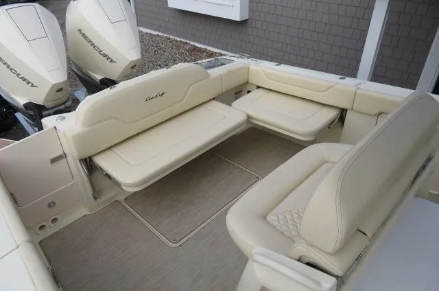 Slide: The Image of 2025 Chris-Craft Catalina 28 boat interior with beige seating and twin Mercury outboard engines. - 15