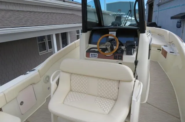 Slide: The Image of 2025 Chris-Craft Catalina 28 boat interior with helm and seating area. - 16