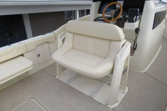 Slide: The Image of 2025 Chris-Craft Catalina 28 boat interior with cream leather seating and steering wheel. - 17