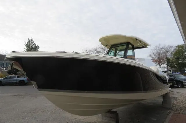 Slide: The Image of 2025 Chris-Craft Catalina 28 boat with sleek design, docked outdoors. - 2