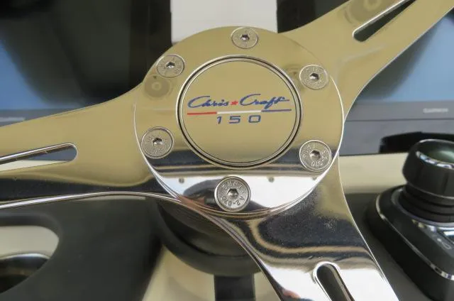 Slide: The Image of Close-up of 2025 Chris-Craft Catalina 28 steering wheel with logo and model number. - 22