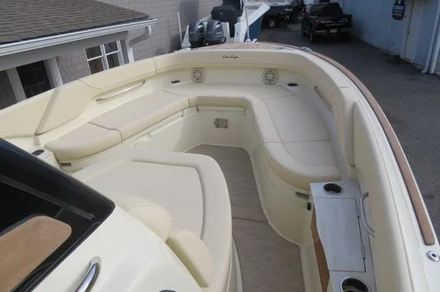 Slide: The Image of 2025 Chris-Craft Catalina 28 boat interior with beige seating and cup holders. - 39