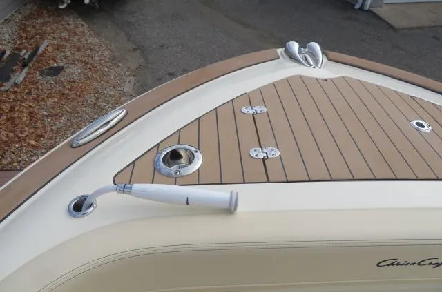Slide: The Image of Chris-Craft Catalina 28 (2025) boat deck with teak finish and stainless steel fittings. - 44
