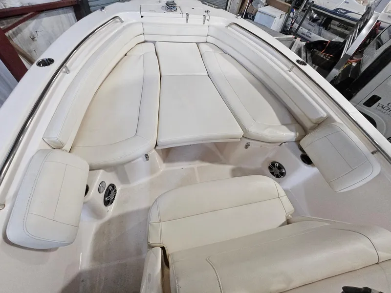 Slide: The Image of 2022 Grady-White Fisherman 257 boat interior with cushioned seating and speakers. - 11