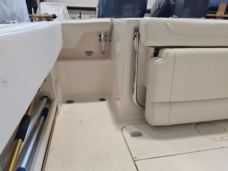 Slide: The Image of 2022 Grady-White Fisherman 257 boat interior with beige seating and storage area. - 16