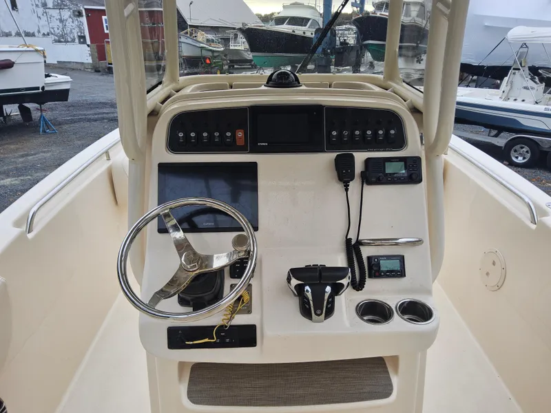 Slide: The Image of 2022 Grady-White Fisherman 257 boat console with steering wheel and navigation controls. - 5