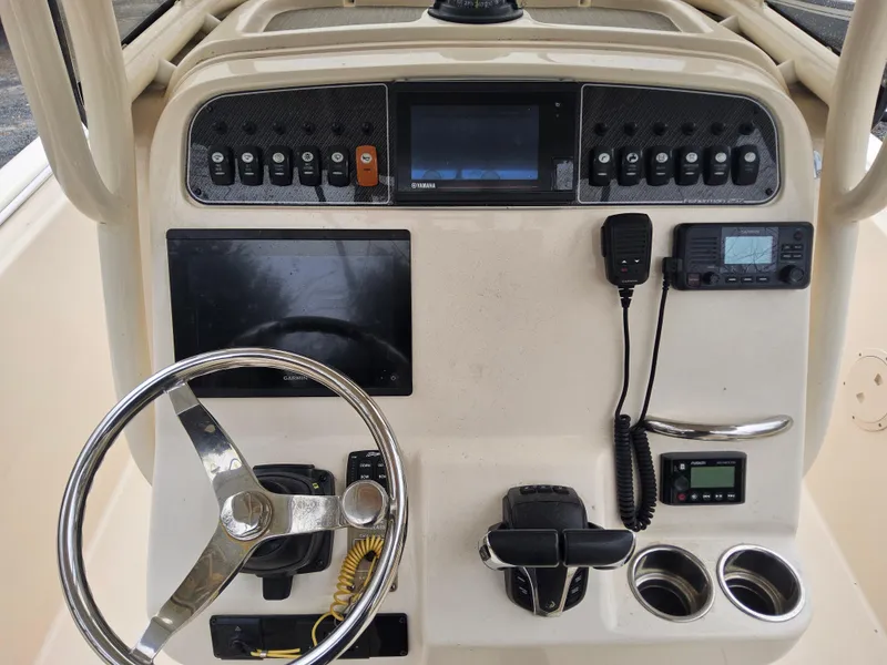 Slide: The Image of 2022 Grady-White Fisherman 257 boat dashboard with steering wheel and electronic controls. - 6
