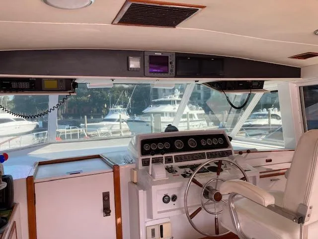 Slide: The Image of Interior helm of 1977 Bertram 58 Motor Yacht with steering wheel and control panel. - 10