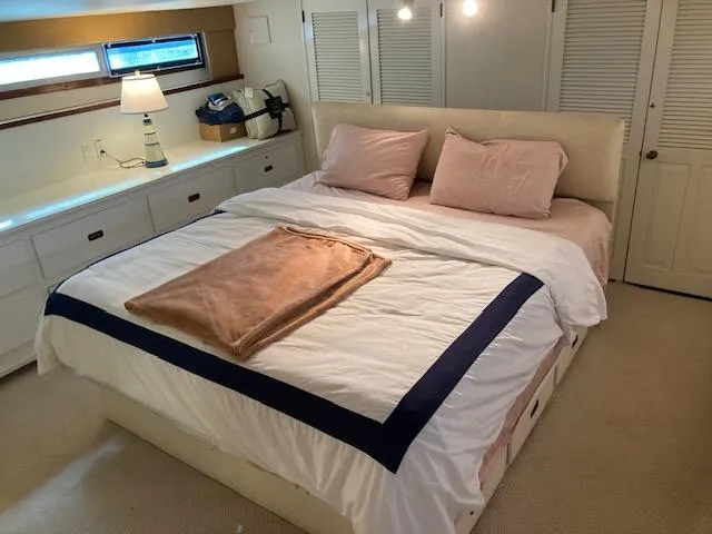 Slide: The Image of Luxurious bedroom interior of 1977 Bertram 58 Motor Yacht with cozy bedding. - 12