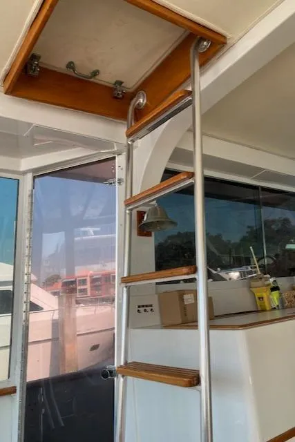 Slide: The Image of Interior view of 1977 Bertram 58 Motor Yacht with ladder and hatch. - 14