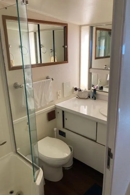 Slide: The Image of 1977 Bertram 58 Motor Yacht bathroom with modern fixtures and mirrored cabinets. - 18