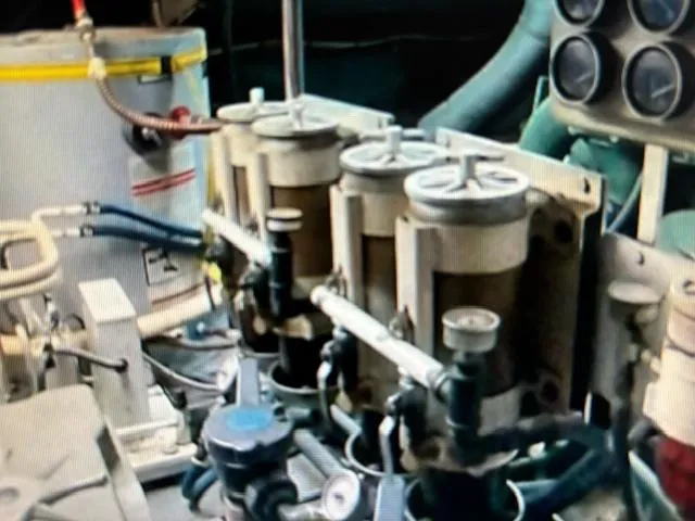Slide: The Image of Engine room of 1977 Bertram 58 Motor Yacht with fuel filters and gauges. - 19