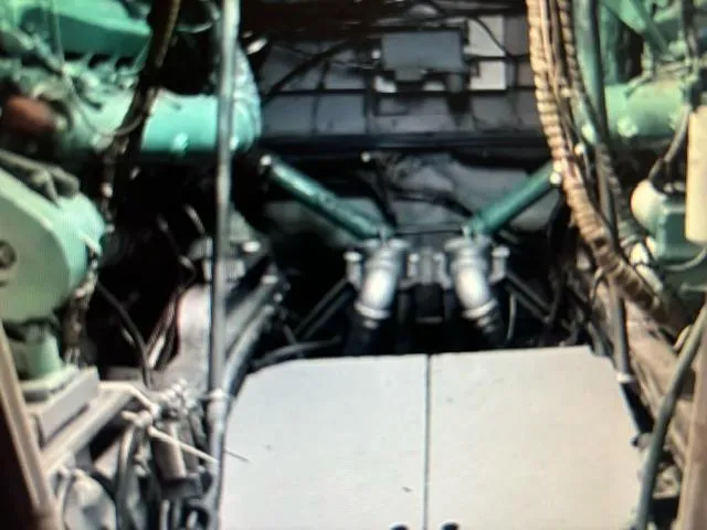 Slide: The Image of Engine room of a 1977 Bertram 58 Motor Yacht, showcasing mechanical components. - 21