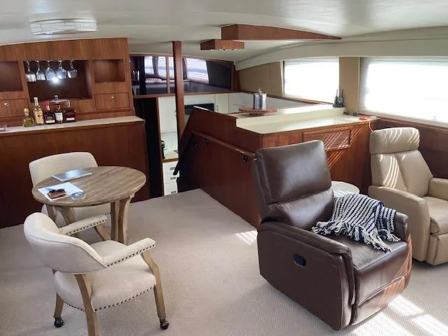 Slide: The Image of Interior of 1977 Bertram 58 Motor Yacht with cozy seating and bar area. - 7