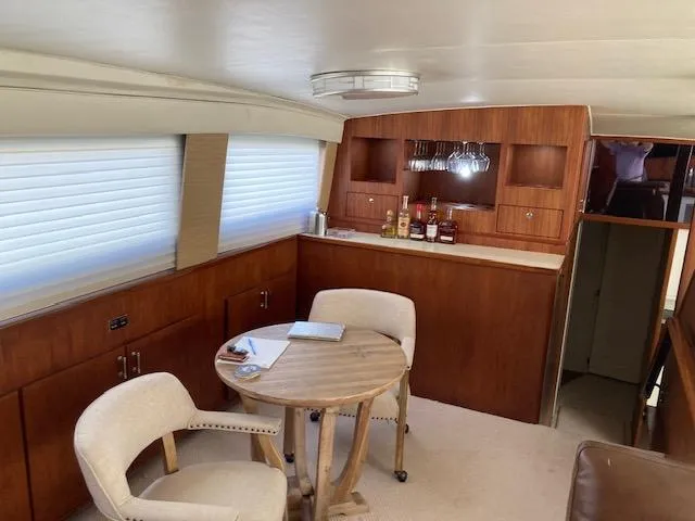Slide: The Image of Interior of 1977 Bertram 58 Motor Yacht with dining area and bar. - 8