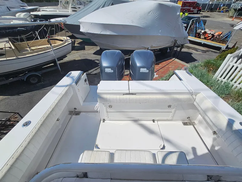 Slide: The Image of 2007 Southport 26 Center Console boat with dual engines in a marina setting. - 13