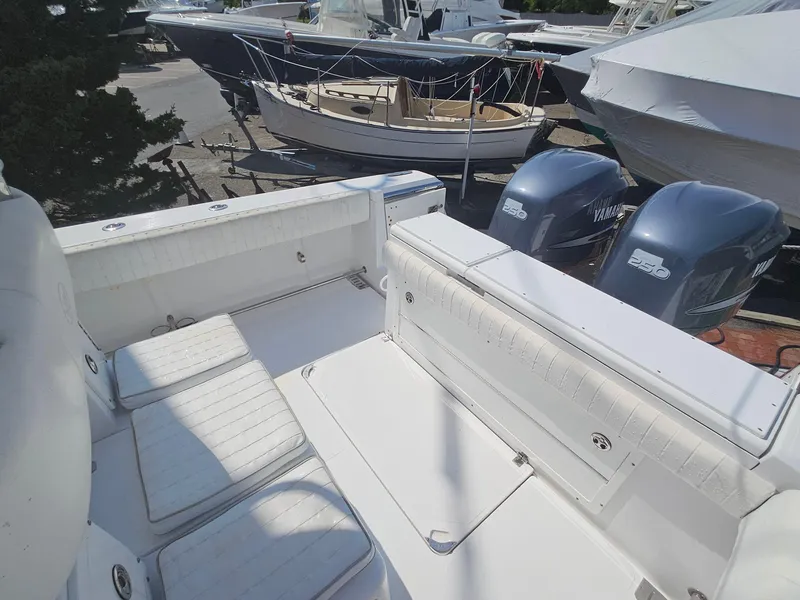 Slide: The Image of 2007 Southport 26 Center Console boat with dual Yamaha engines, docked in a marina. - 14