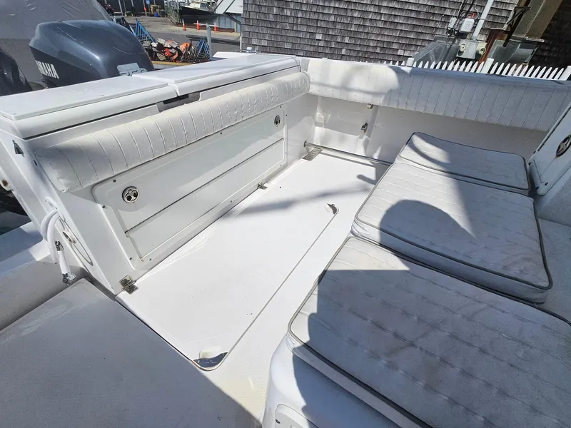 Slide: The Image of 2007 Southport 26 Center Console boat interior with cushioned seating and storage. - 16