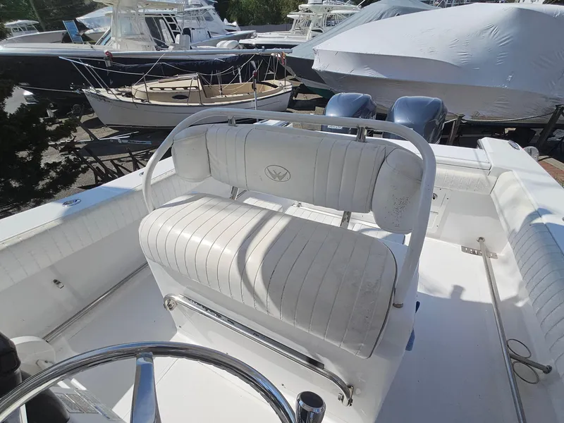 Slide: The Image of 2007 Southport 26 Center Console boat interior with white seating and steering wheel. - 17