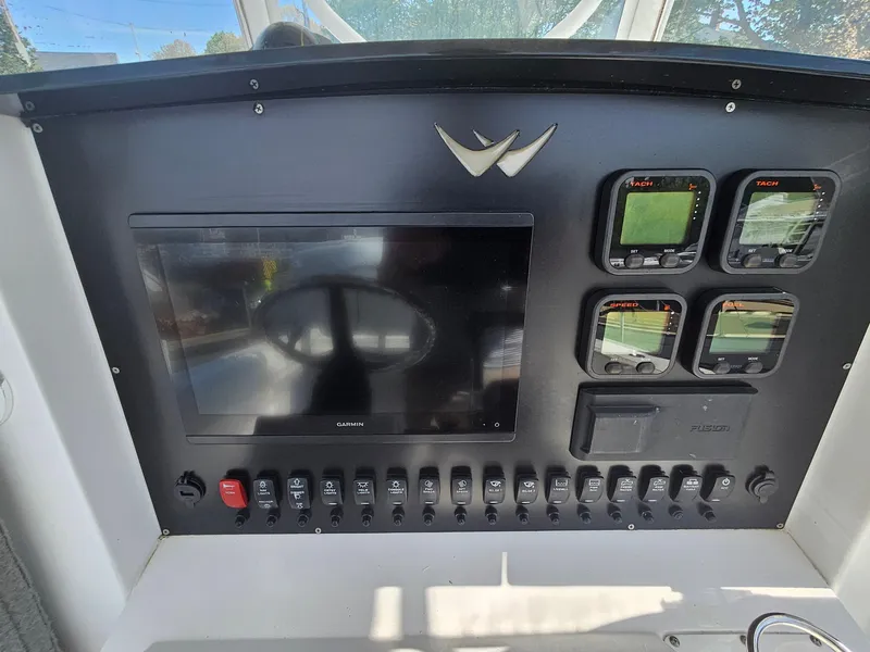 Slide: The Image of Control panel of a 2007 Southport 26 Center Console boat with navigation screens. - 20