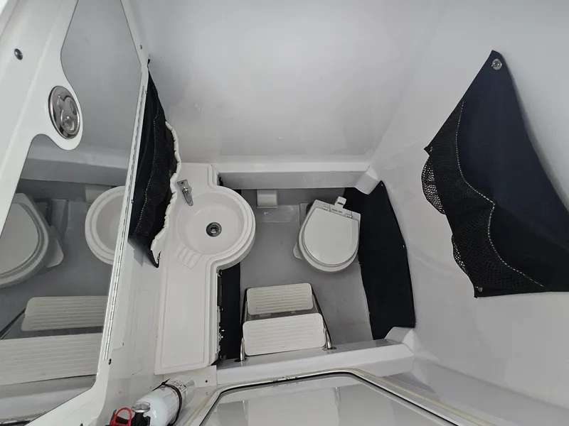 Slide: The Image of 2007 Southport 26 Center Console boat interior with sink and toilet. - 23