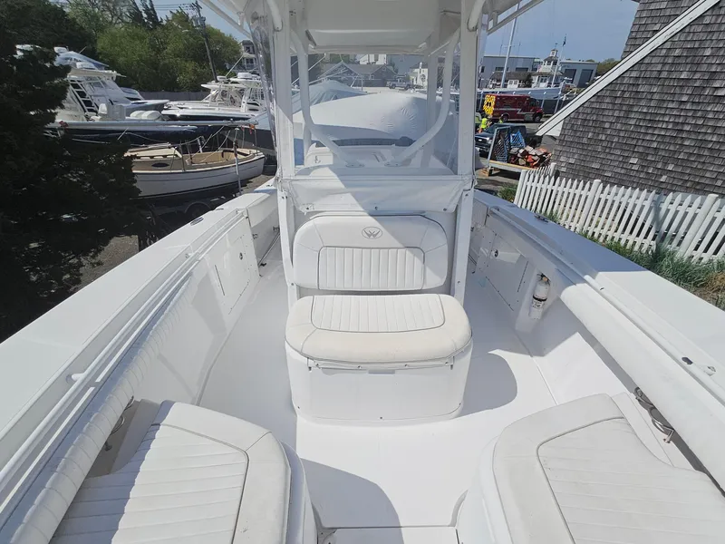 Slide: The Image of 2007 Southport 26 Center Console boat with white seating and spacious deck. - 24