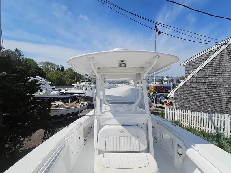 Slide: The Image of 2007 Southport 26 Center Console boat docked, surrounded by other boats and a wooden fence. - 25