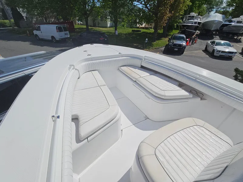 Slide: The Image of 2007 Southport 26 Center Console boat with cushioned seating, parked outdoors. - 27