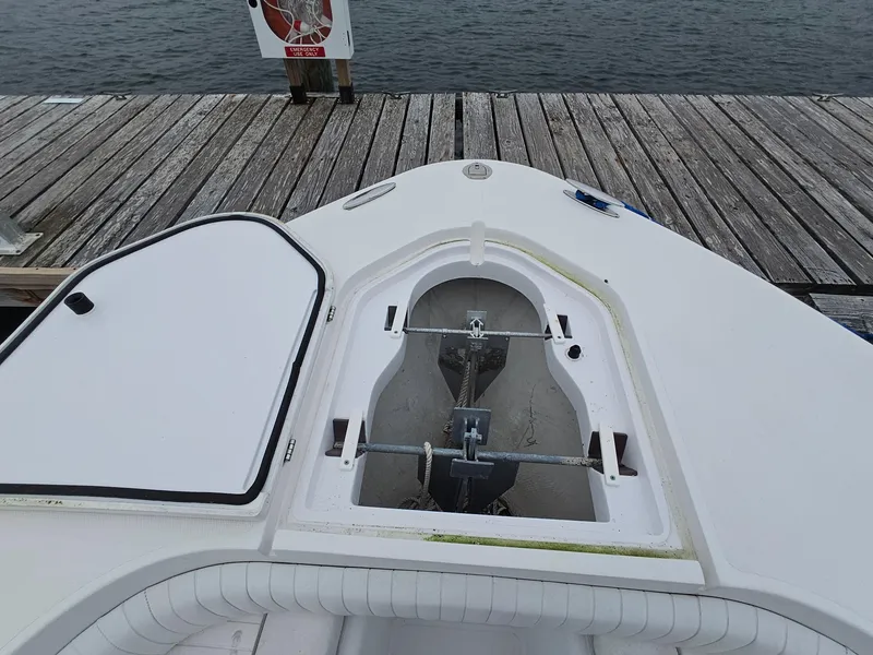 Slide: The Image of 2007 Southport 26 Center Console boat anchor compartment at dock. - 28