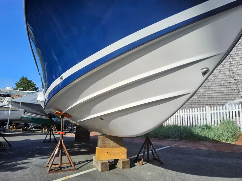 Slide: The Image of 2007 Southport 26 Center Console boat on stands, blue and white hull, outdoor setting. - 3