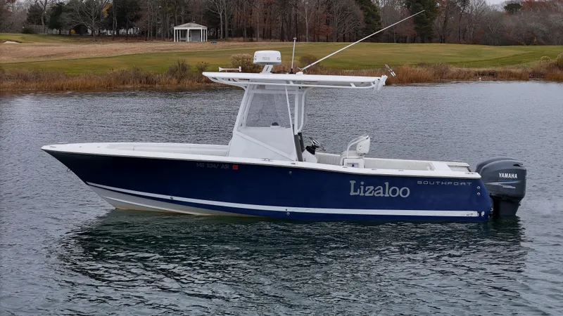 Slide: The Image of 2007 Southport 26 Center Console boat on calm water, side view. - 31
